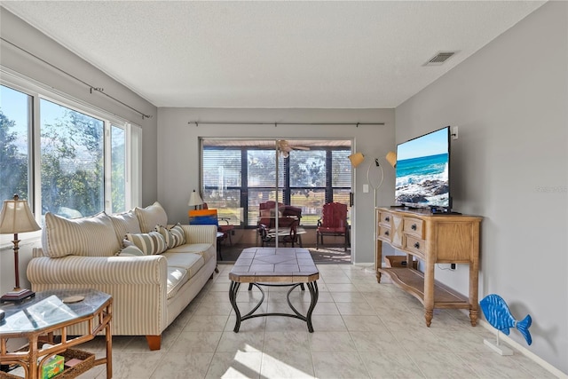 living room with light tile patterned floors and a textured ceiling