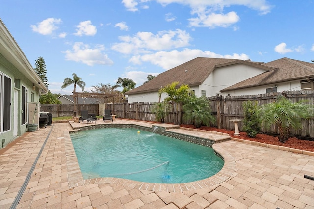 view of swimming pool featuring pool water feature, a pergola, a grill, and a patio