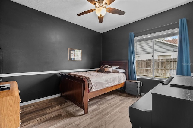 bedroom with ceiling fan and hardwood / wood-style floors