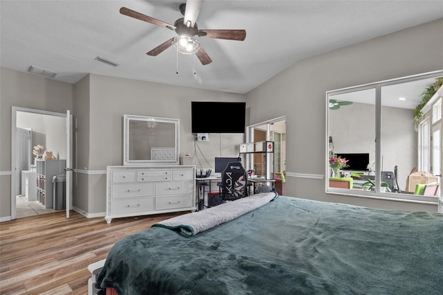 bedroom featuring vaulted ceiling, a textured ceiling, ceiling fan, and light hardwood / wood-style floors