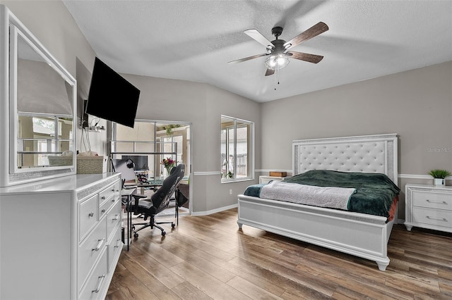 bedroom with ceiling fan, a textured ceiling, and wood-type flooring