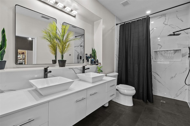 bathroom featuring toilet, curtained shower, and vanity