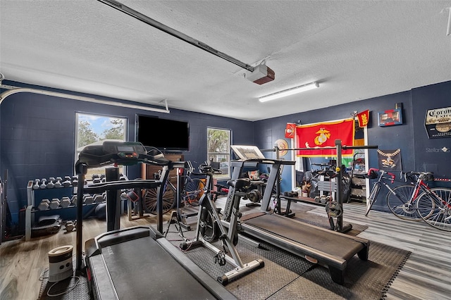 workout area with a textured ceiling and hardwood / wood-style flooring