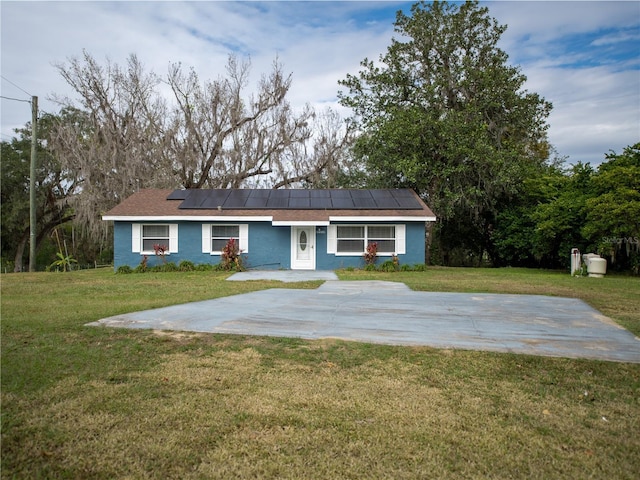 single story home with a front lawn and solar panels