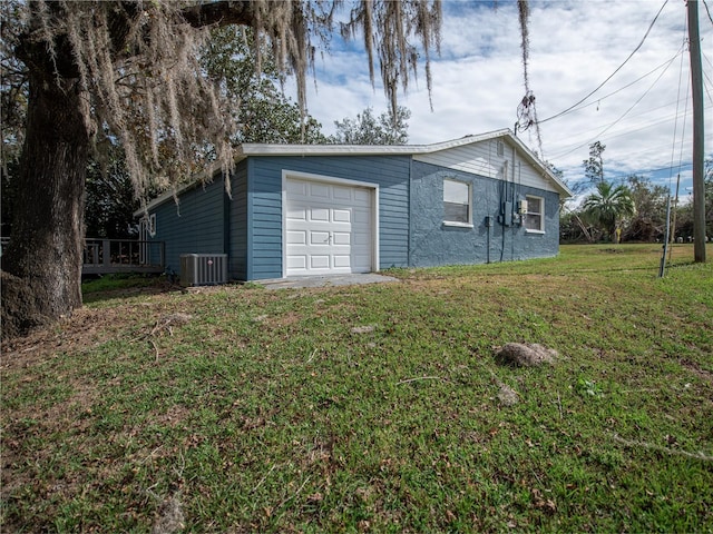 view of property exterior with a garage, a yard, and central air condition unit