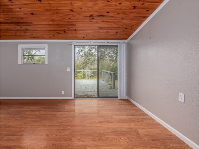 spare room with light hardwood / wood-style flooring, vaulted ceiling, a wealth of natural light, and wood ceiling