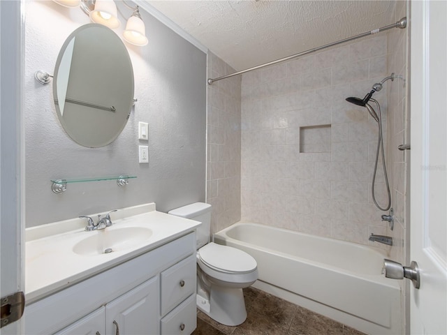 full bathroom featuring tile patterned flooring, tiled shower / bath, toilet, a textured ceiling, and vanity