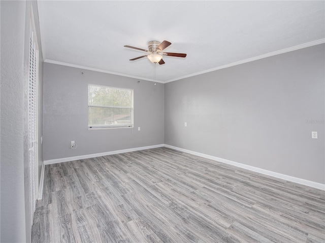 spare room with ceiling fan, light hardwood / wood-style flooring, and crown molding