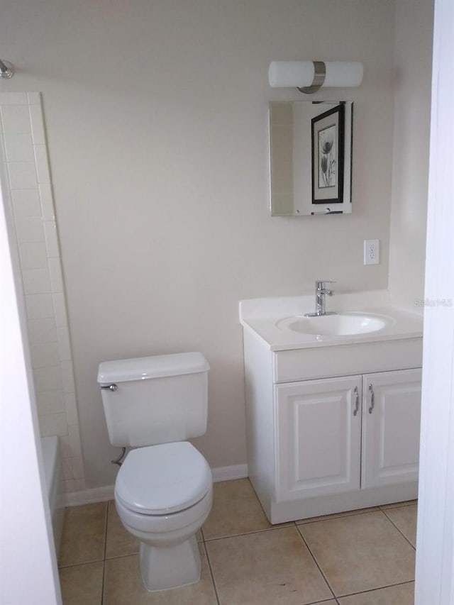 bathroom featuring vanity, toilet, and tile patterned flooring