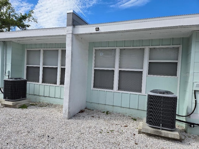 view of side of property with central air condition unit