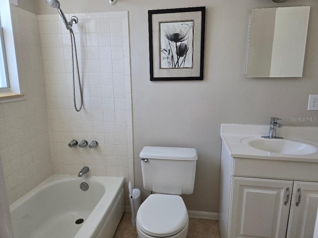 full bathroom featuring tiled shower / bath, vanity, and toilet