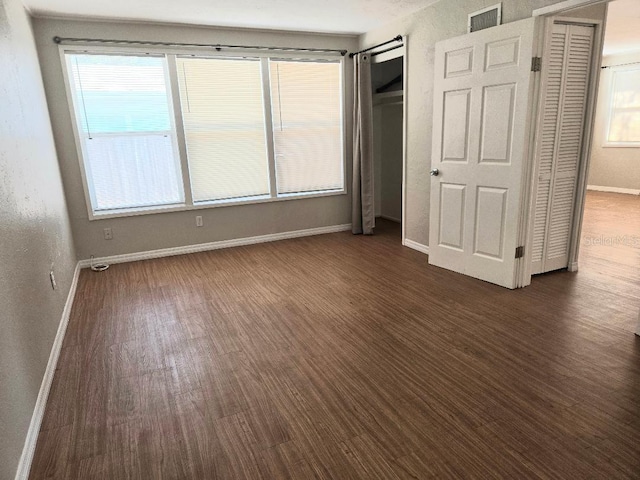 unfurnished bedroom featuring dark hardwood / wood-style flooring