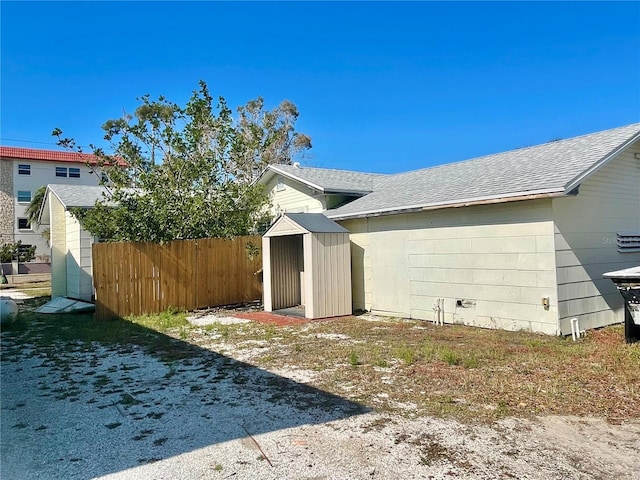 view of home's exterior with a storage unit