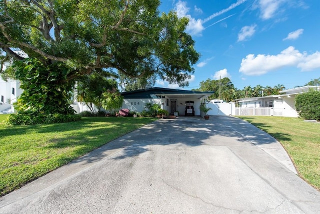 ranch-style home with a carport and a front lawn