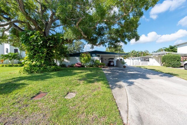 604 Danube Ave, Tampa, FL 33606 - ranch-style house with a carport and a front yard