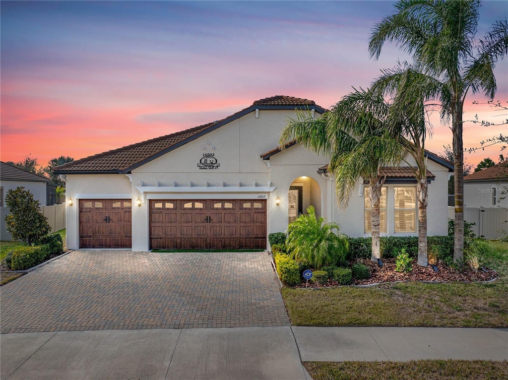 mediterranean / spanish-style house featuring a garage