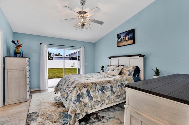 bedroom featuring access to outside, lofted ceiling, ceiling fan, and light hardwood / wood-style floors