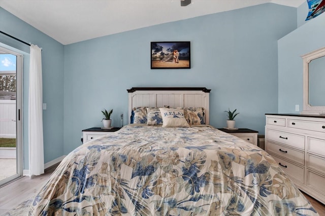 bedroom with lofted ceiling, light hardwood / wood-style floors, and access to outside