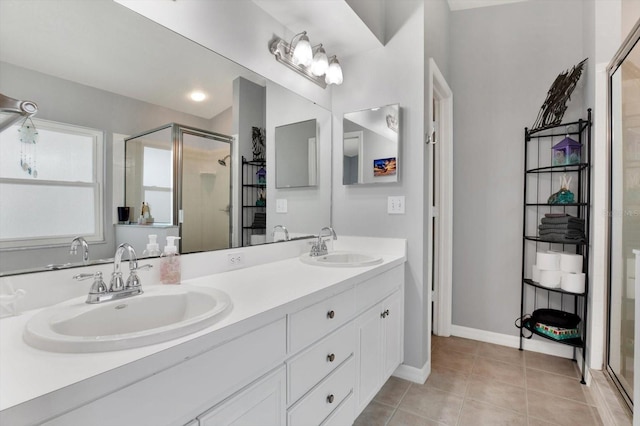 bathroom featuring a shower with door, vanity, and tile patterned flooring