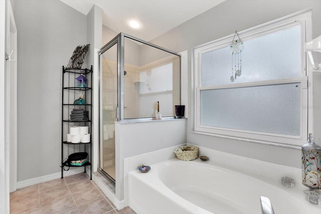 bathroom featuring tile patterned floors, a healthy amount of sunlight, and plus walk in shower