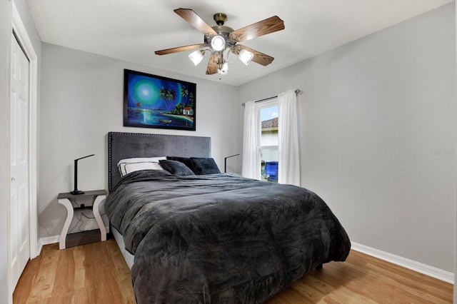 bedroom featuring ceiling fan, hardwood / wood-style floors, and a closet