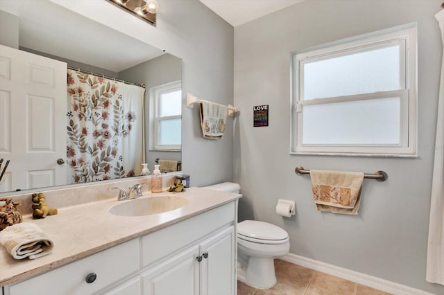 bathroom with toilet, vanity, tile patterned floors, and walk in shower