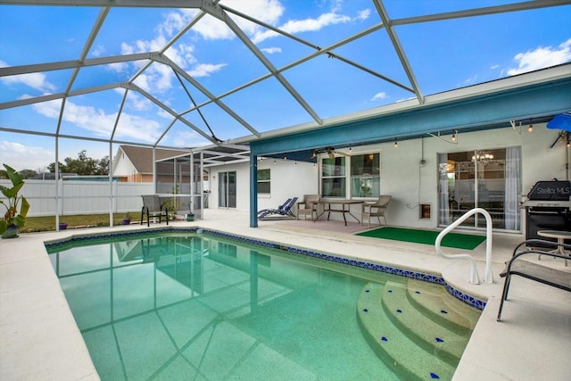 view of swimming pool with a patio area and glass enclosure