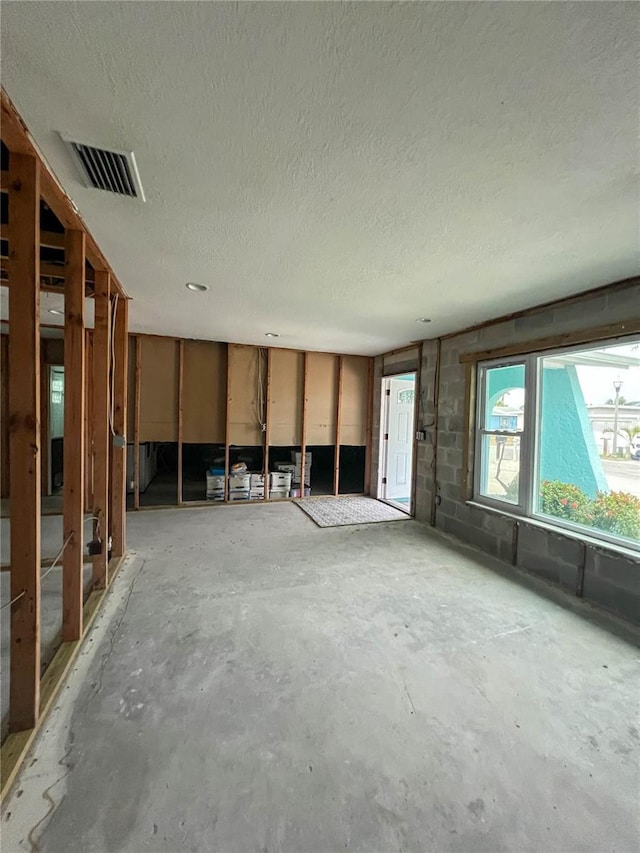 interior space featuring concrete floors and a textured ceiling