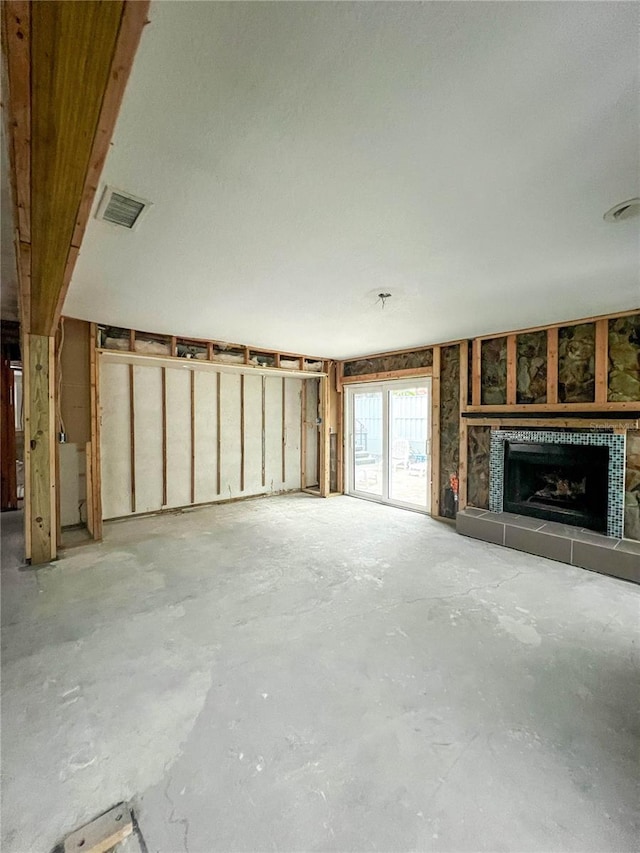 unfurnished living room with a tile fireplace