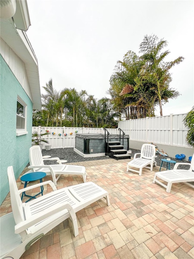 view of patio with a hot tub