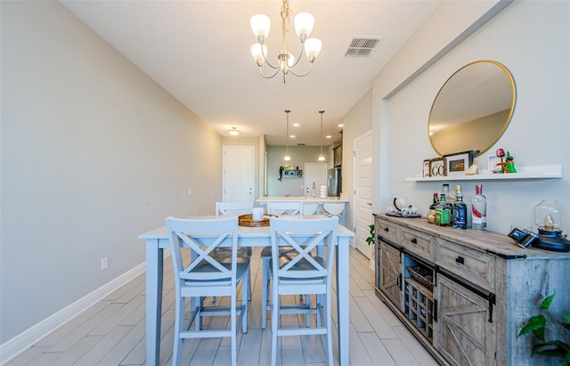 dining area with an inviting chandelier