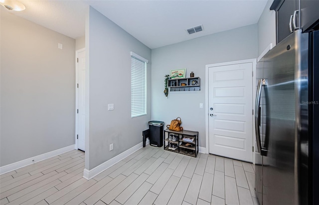 kitchen with light hardwood / wood-style floors and stainless steel refrigerator