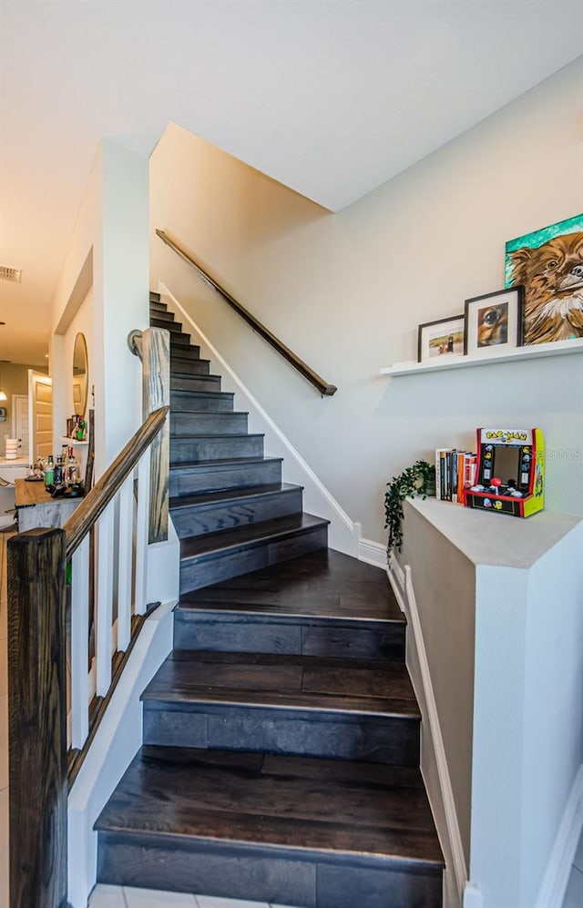 staircase with hardwood / wood-style flooring