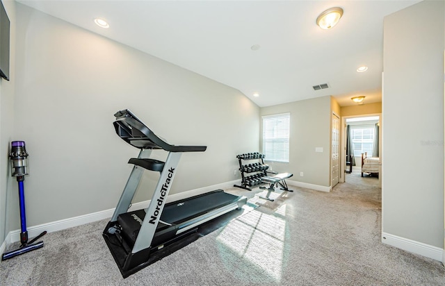 exercise room featuring light carpet and lofted ceiling