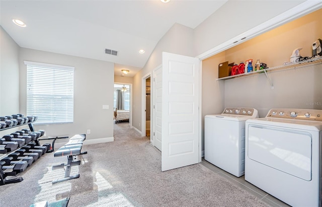 clothes washing area featuring a wealth of natural light, light carpet, and independent washer and dryer