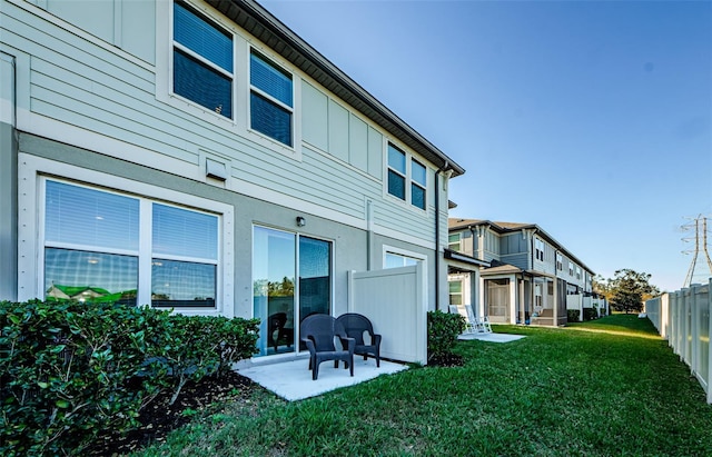 rear view of house featuring a lawn