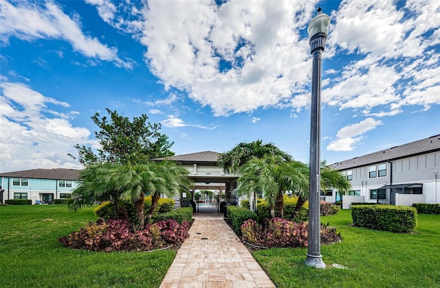 view of front of home featuring a front lawn and a carport