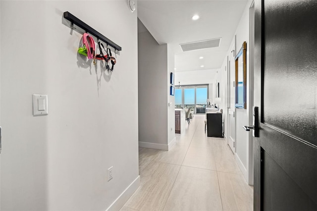 hall featuring light tile patterned floors