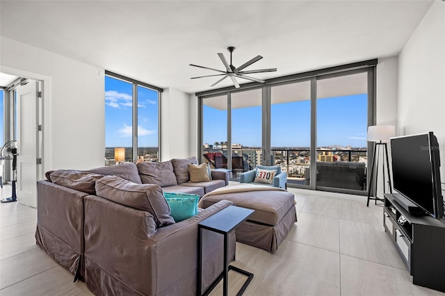 living room featuring ceiling fan and expansive windows