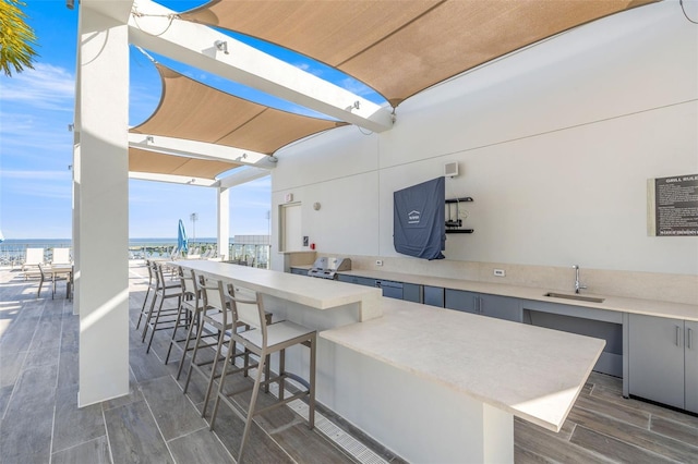 view of patio with an outdoor wet bar