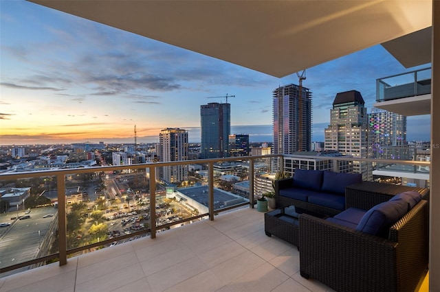 balcony at dusk featuring outdoor lounge area