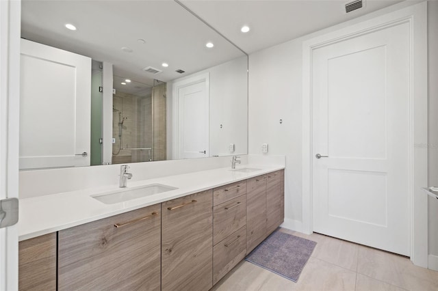 bathroom with vanity, tile patterned flooring, and a shower with door