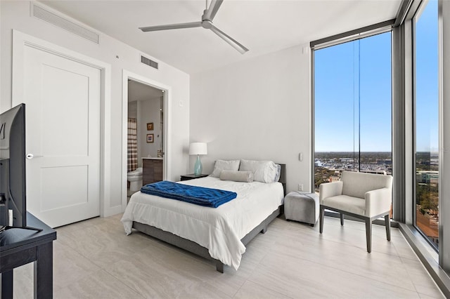 bedroom with ceiling fan, ensuite bath, floor to ceiling windows, and multiple windows