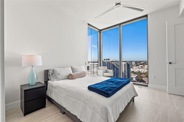 bedroom featuring ceiling fan and expansive windows