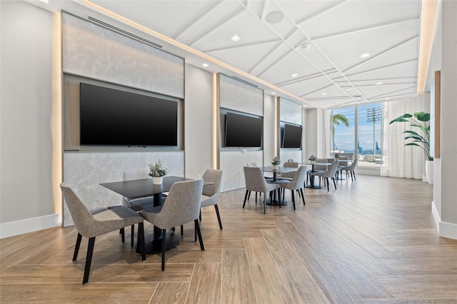 dining room featuring parquet floors, coffered ceiling, and expansive windows