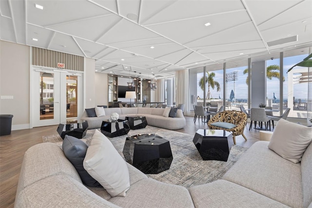 living room with french doors, floor to ceiling windows, and hardwood / wood-style floors