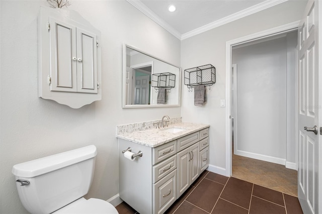 bathroom featuring vanity, crown molding, tile patterned floors, and toilet