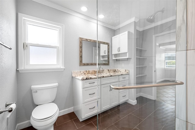 bathroom with tile patterned floors, crown molding, vanity, and toilet