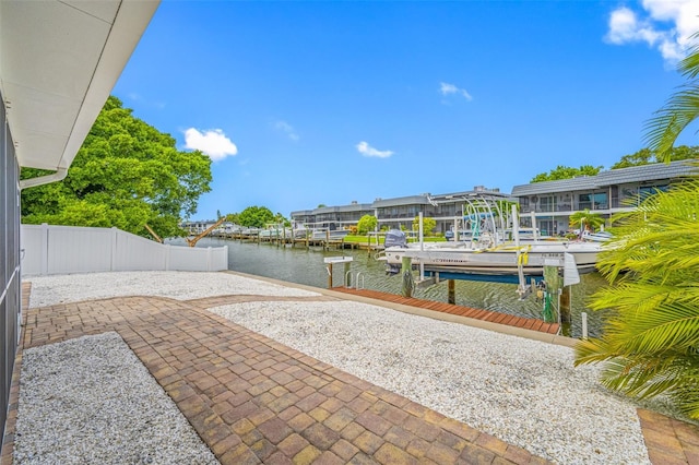 view of patio / terrace with a boat dock and a water view