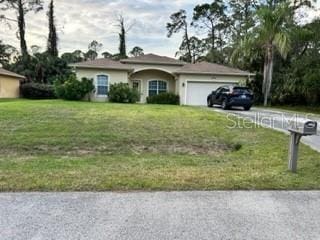 single story home with a front lawn and a garage